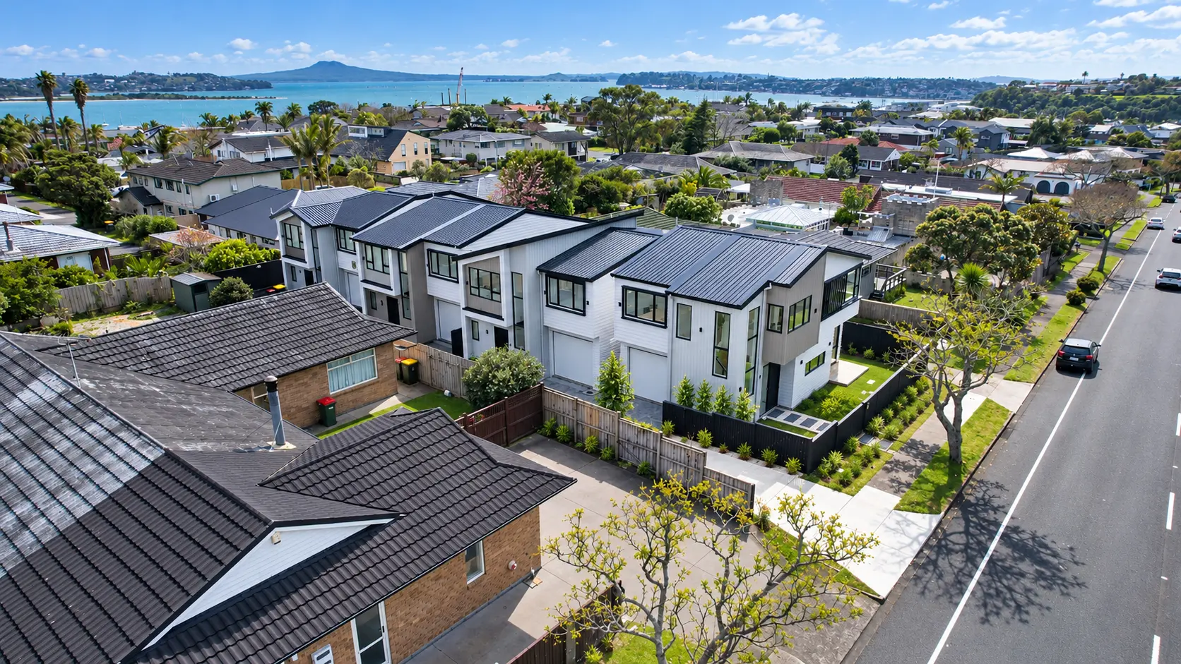 Aerial view of the four standalone homes and their Half Moon Bay setting