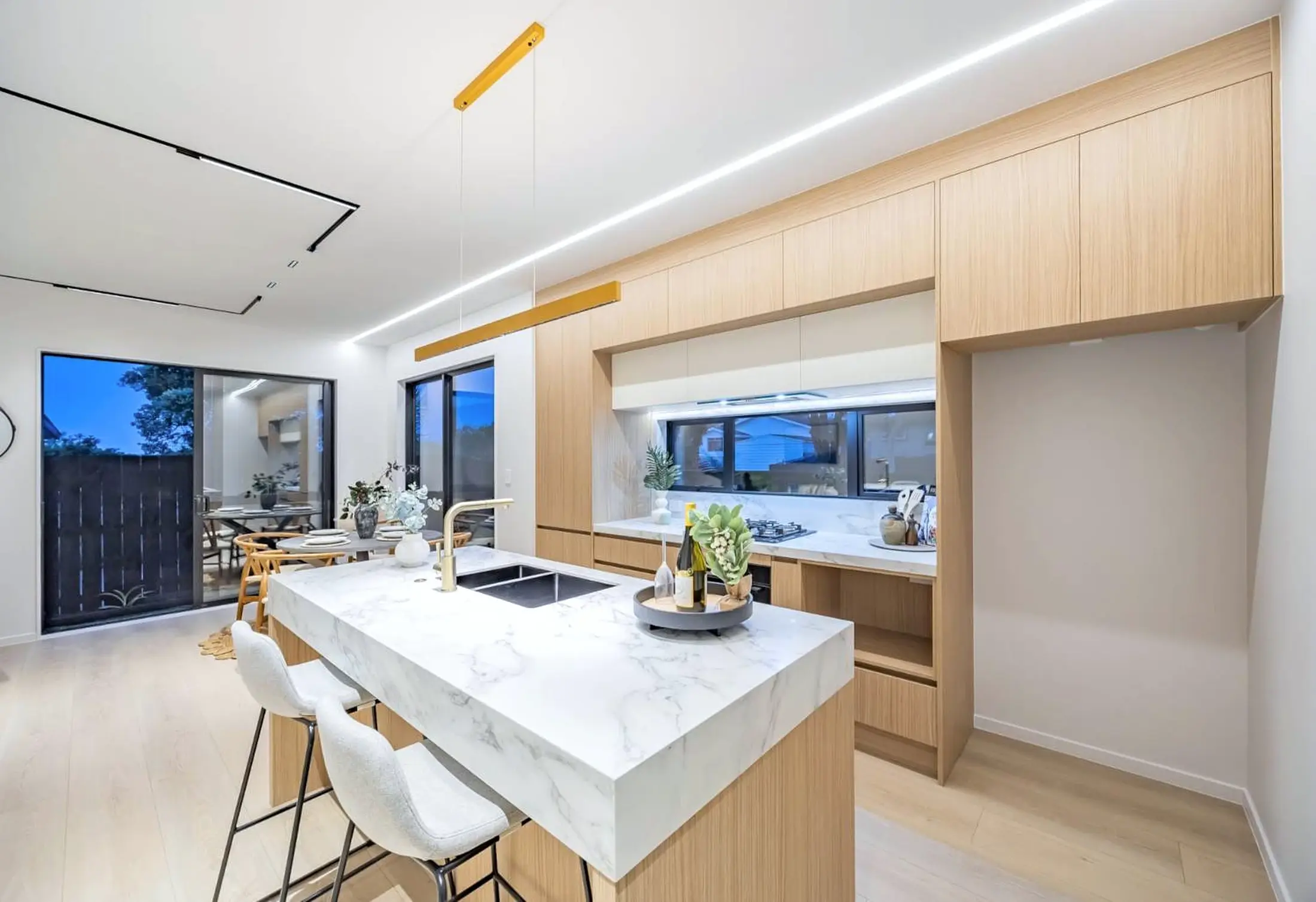 Kitchen with timber cabinetry and stone island bench