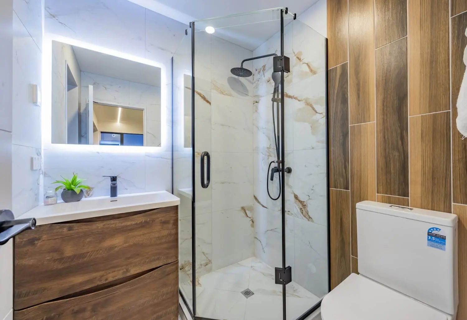 Bathroom with timber cabinetry and a glass shower