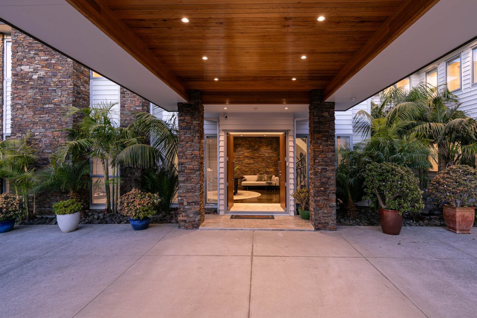 Covered arrival to 2A Oscar Road with stone walls and timber soffit