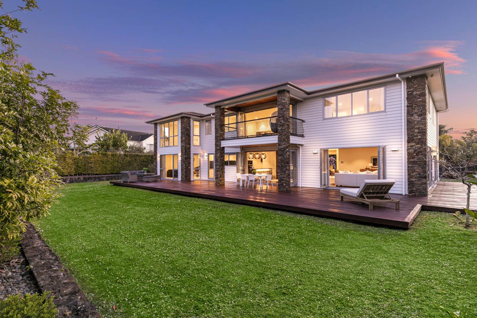Living areas opening toward the landscaped lawn at 2A Oscar Road