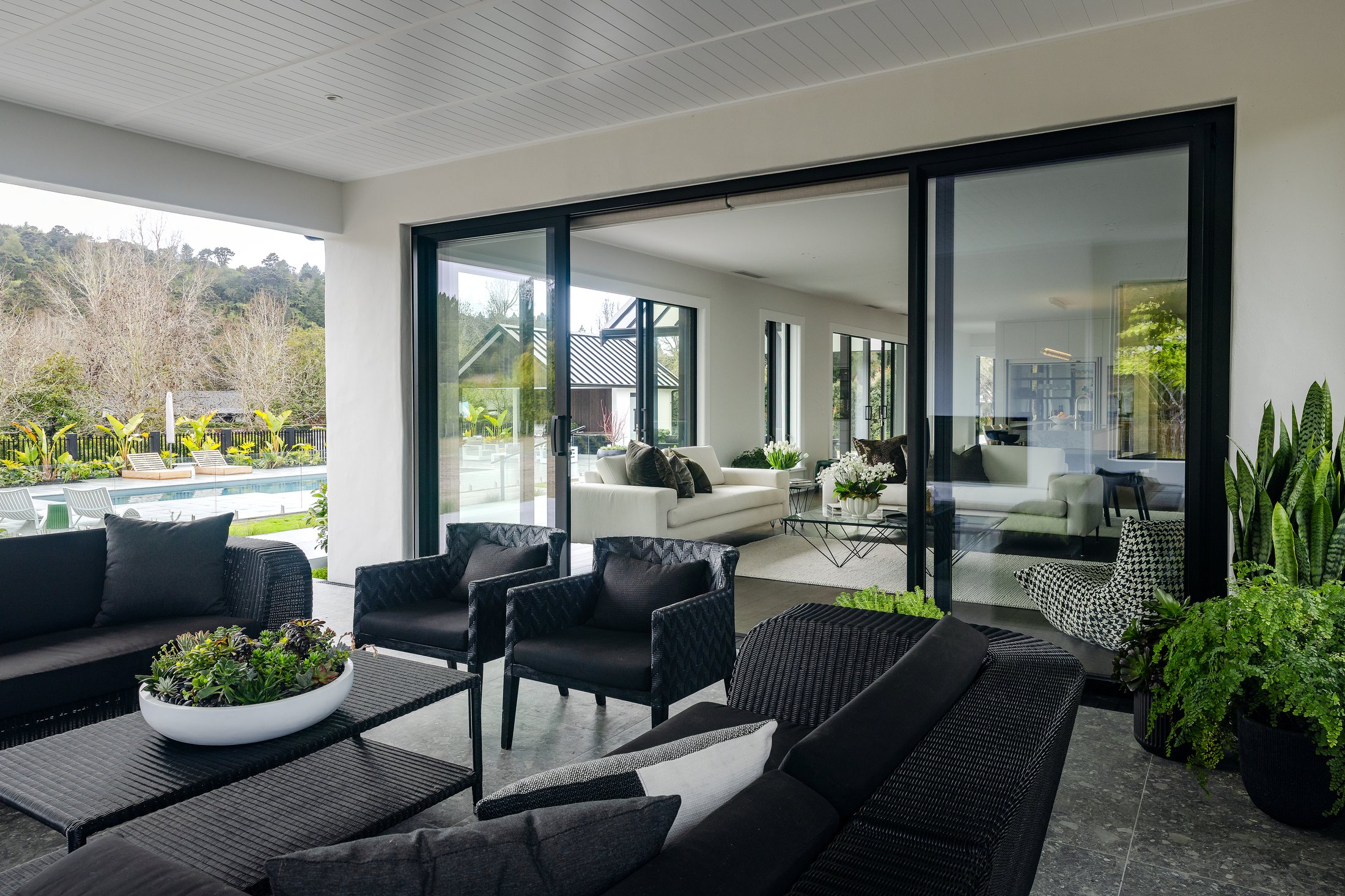 Covered outdoor sitting area beside the pool