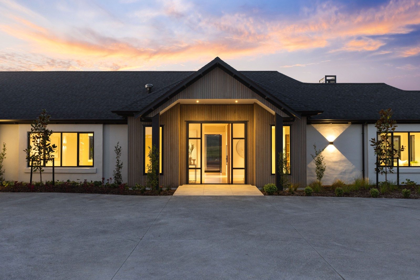 Gabled arrival and warm lighting at dusk