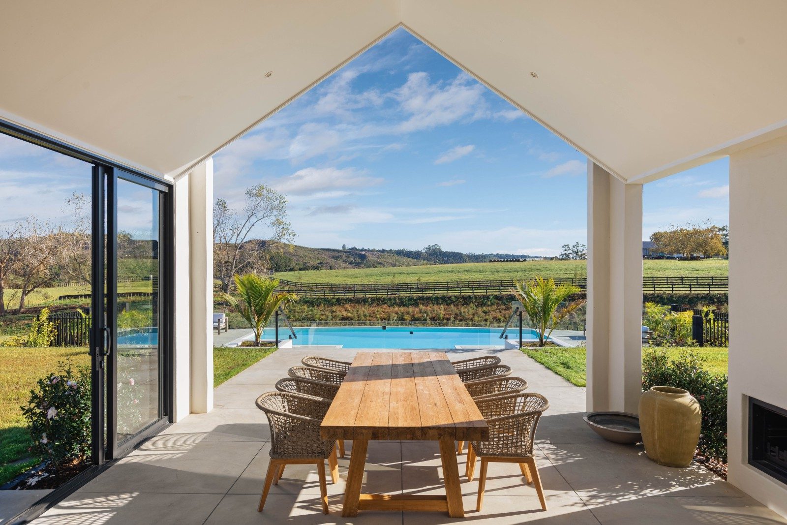 Covered outdoor dining framed toward the countryside