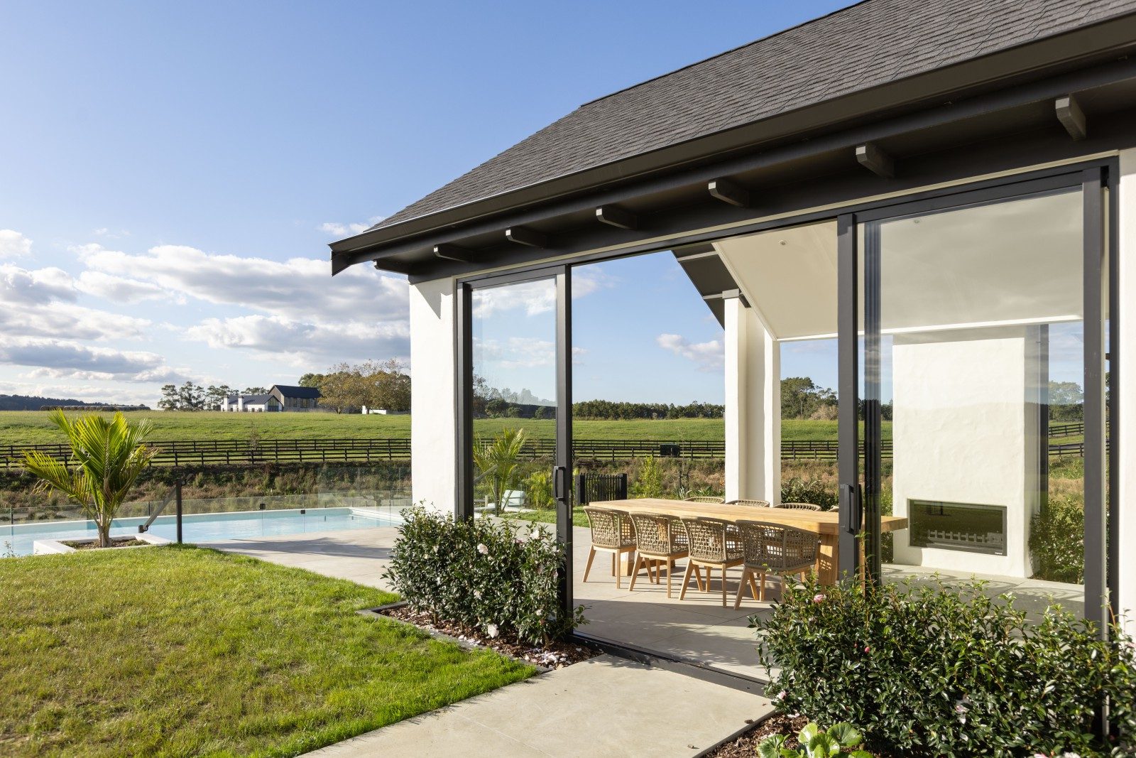 Covered terrace beside the pool and lawn