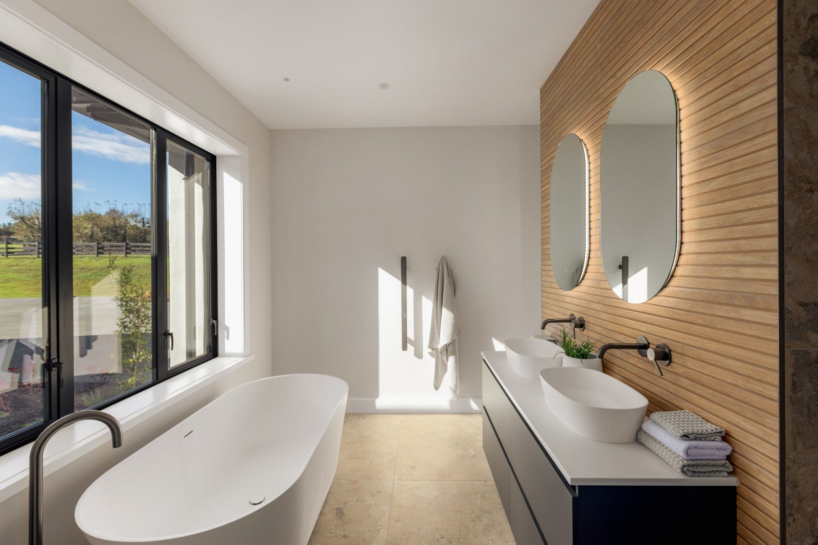 Bathroom with freestanding bath and timber detail