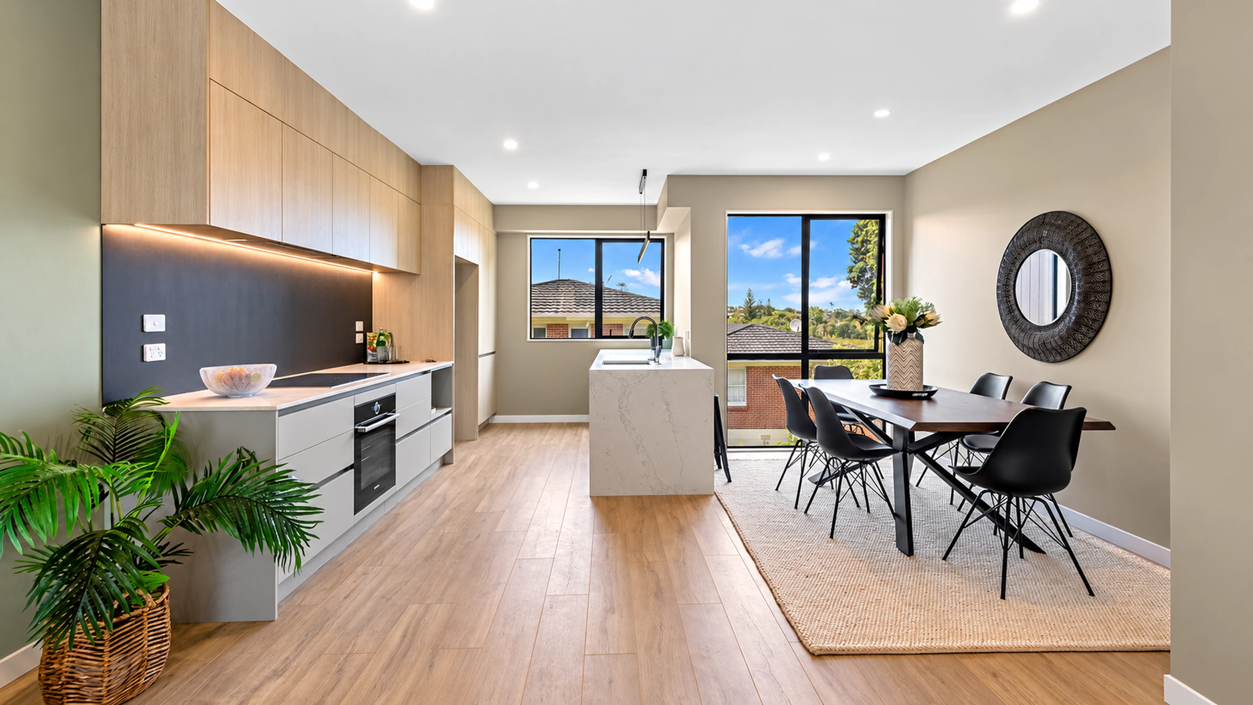Kitchen and dining area with timber flooring and large windows