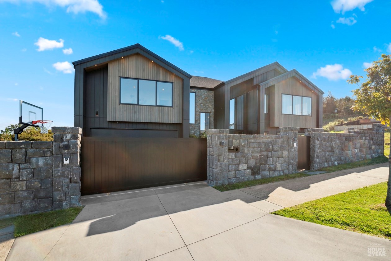 Closer view of the home's gabled street facade and stone boundary walls