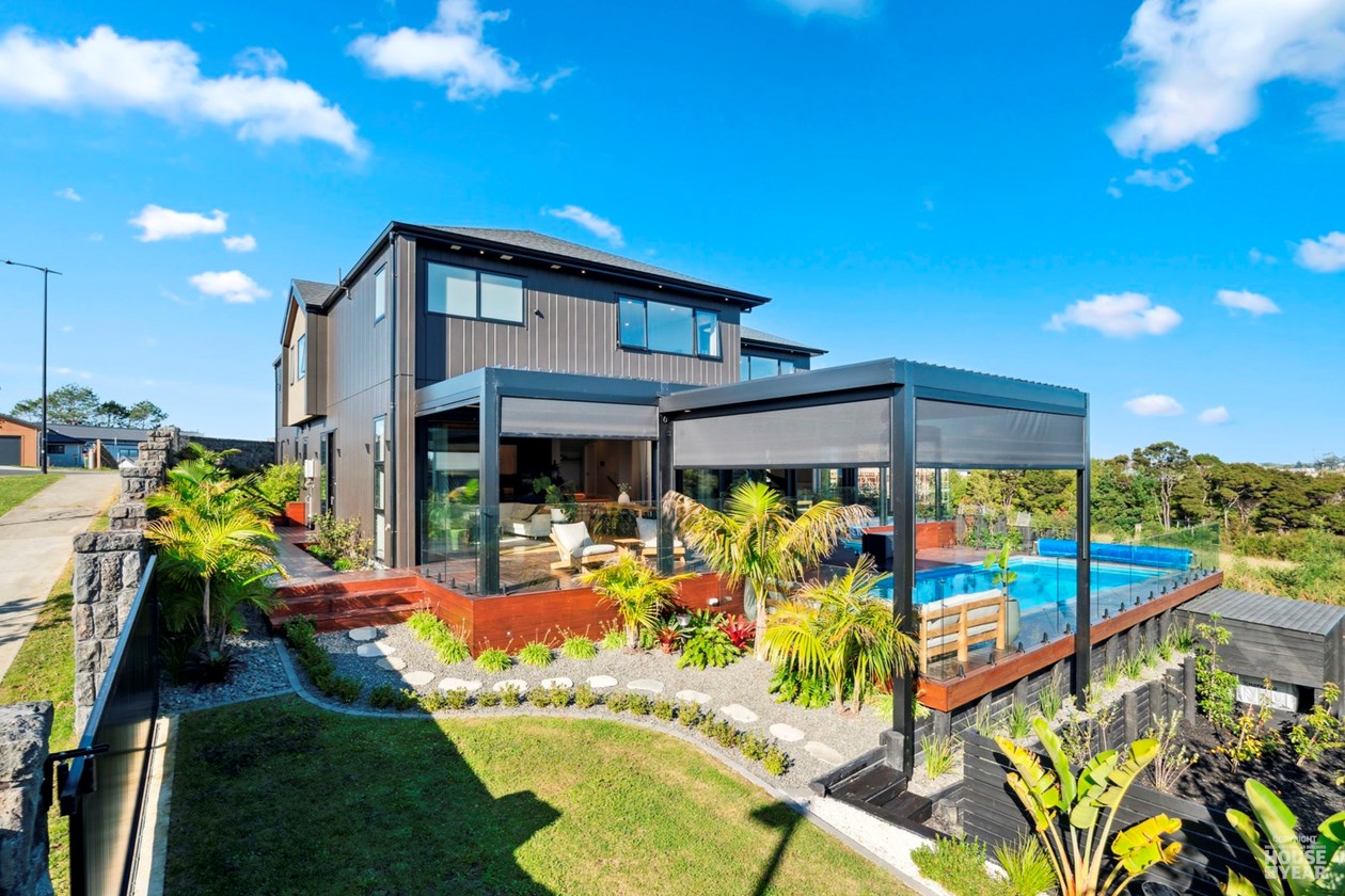 Rear garden view of the home, pool and covered outdoor space