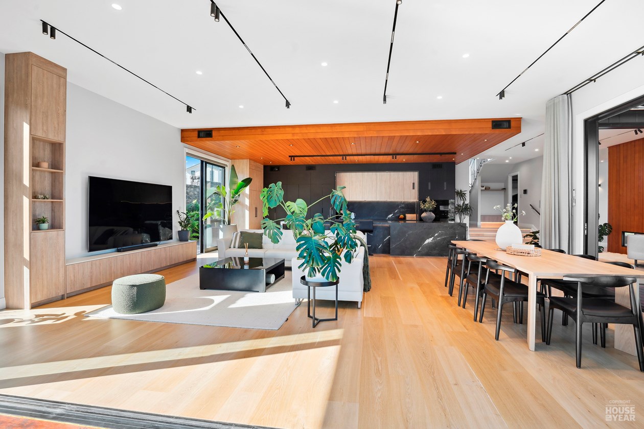 Open-plan living and dining room with timber ceiling and kitchen
