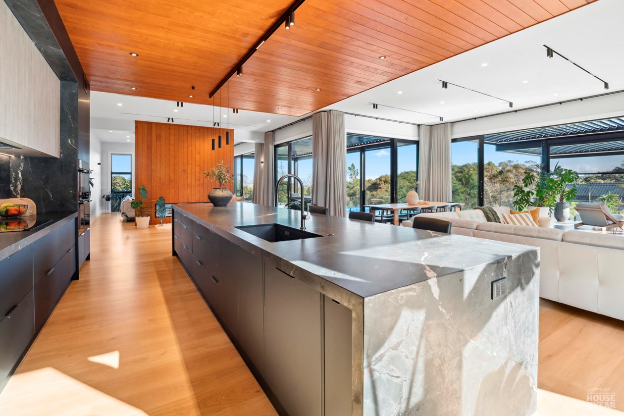Stone kitchen island with views through the living room