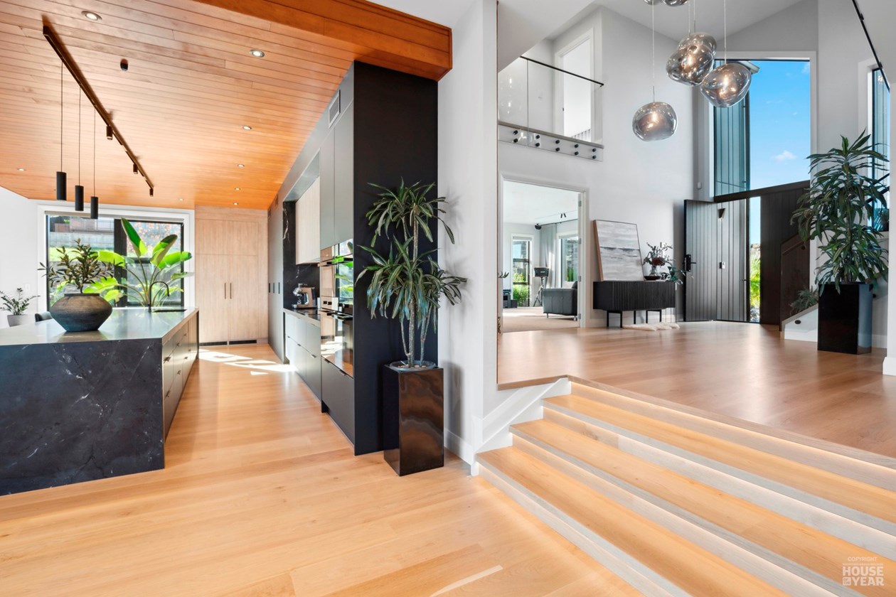Kitchen and double-height entry space with timber detailing