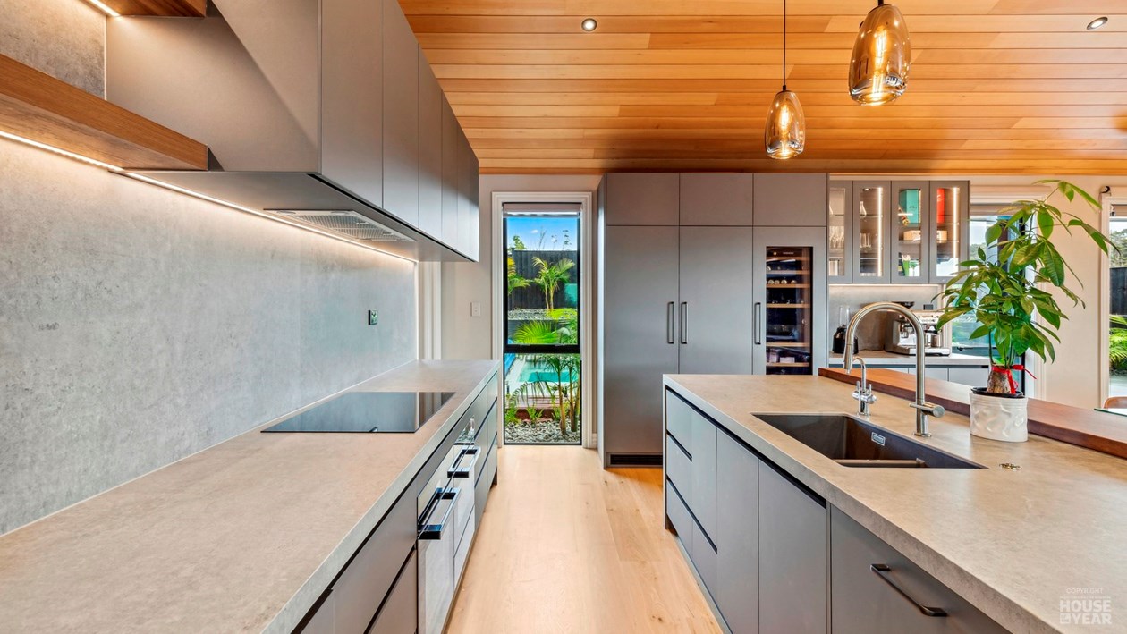 Kitchen with stone worktops and timber ceiling at 44 Kewa Road