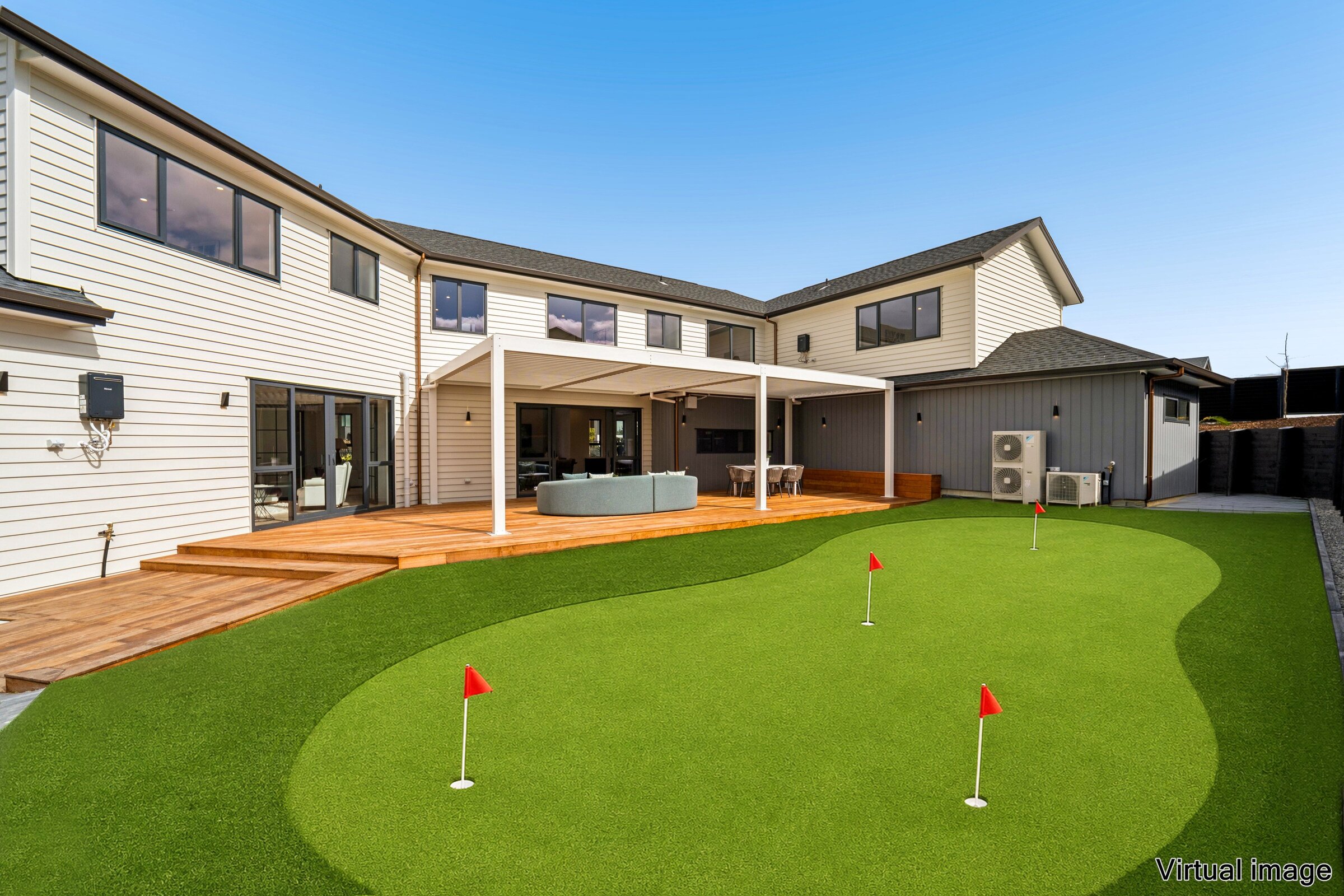 Landscaped putting green and covered outdoor terrace at 73 Kewa Road