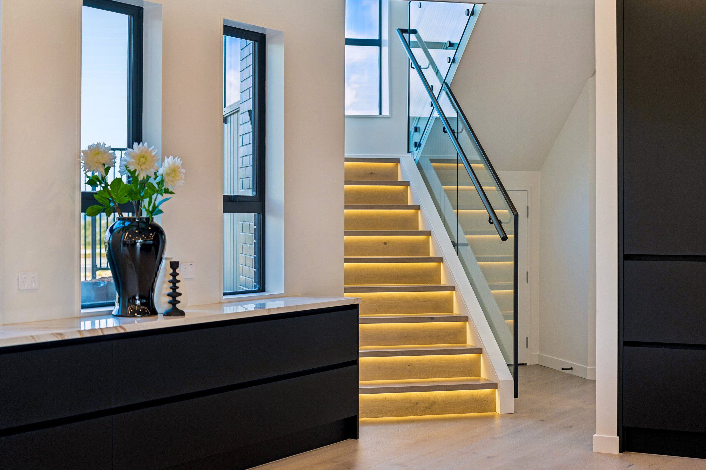 Illuminated stair at the central entry of 73 Kewa Road